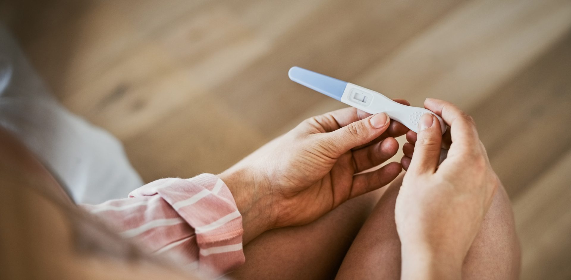 Cropped shot of an unrecognizable woman holding a negative pregnancy test