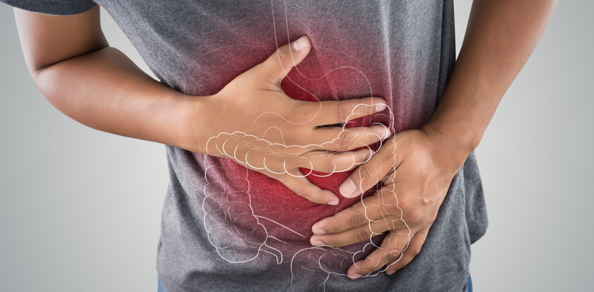 The photo of large intestine is on the man's body against gray background, People With Stomach ache problem concept, Male anatomy